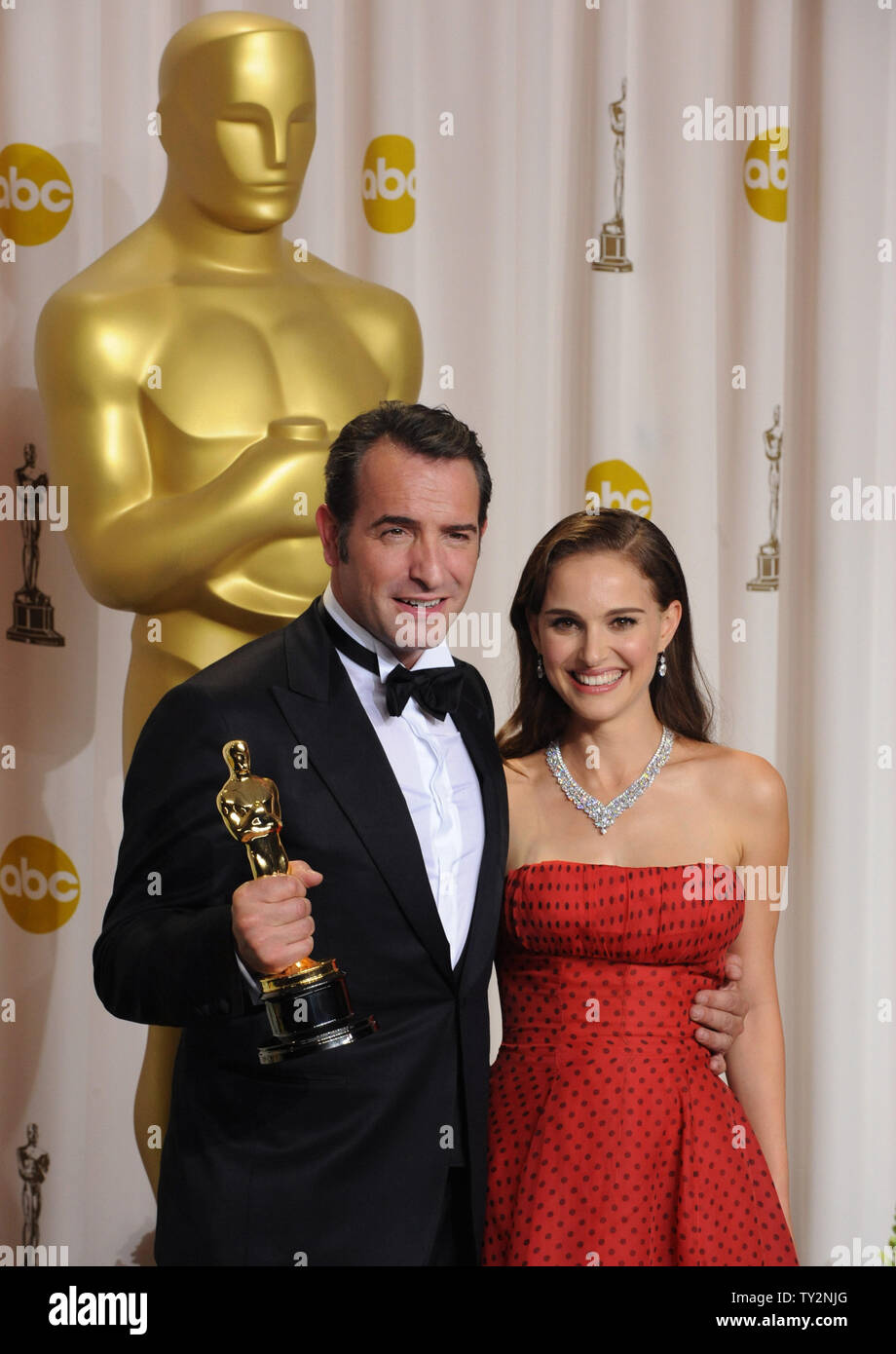 Best Actor Jean Dujardin for the movie "The Artist" appears with presenter  Natalie Portman backstage at the 84th Academy Awards at the Hollywood and  Highlands Center in Los Angeles on February 26,