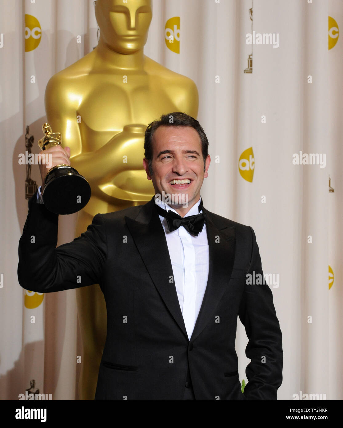 Best Actor Oscar winner Jean Dujardin holds his Oscar backstage at the 84th  annual Academy Awards