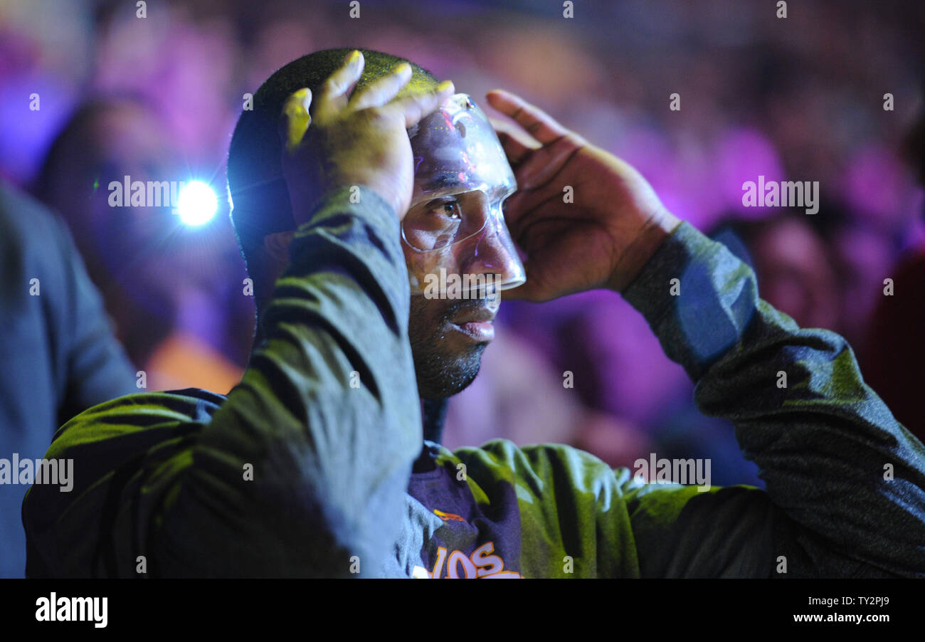 Los Angeles Lakers shooting guard Kobe Bryant puts on his mask to protect his fractured nose before the game against the Miami Heat in an NBA basketball game in Los Angeles on March 4, 2012.    UPI/Lori Shepler Stock Photo