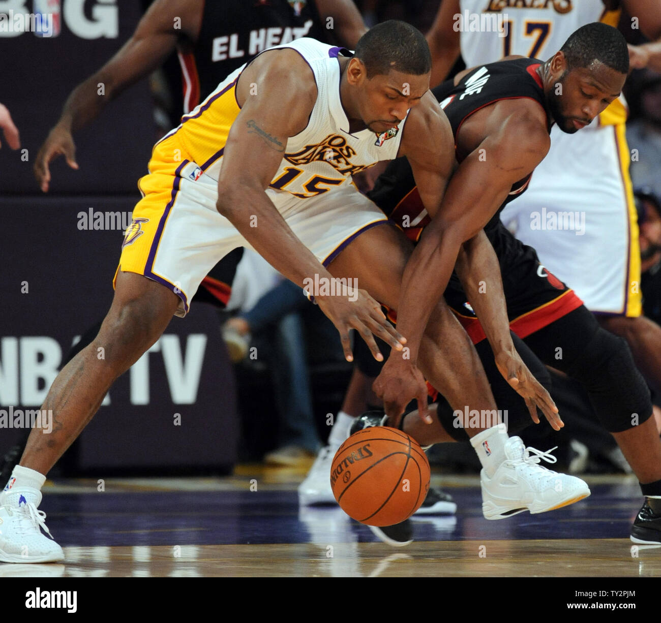 Los Angeles Lakers small forward Metta World Peace (15) and Miami Heat shooting guard Dwyane Wade (3) battle for the ball in the second half of  their NBA basketball game in Los Angeles on March 4, 2012.  The Lakers won 93 to 83.  UPI/Lori Shepler Stock Photo