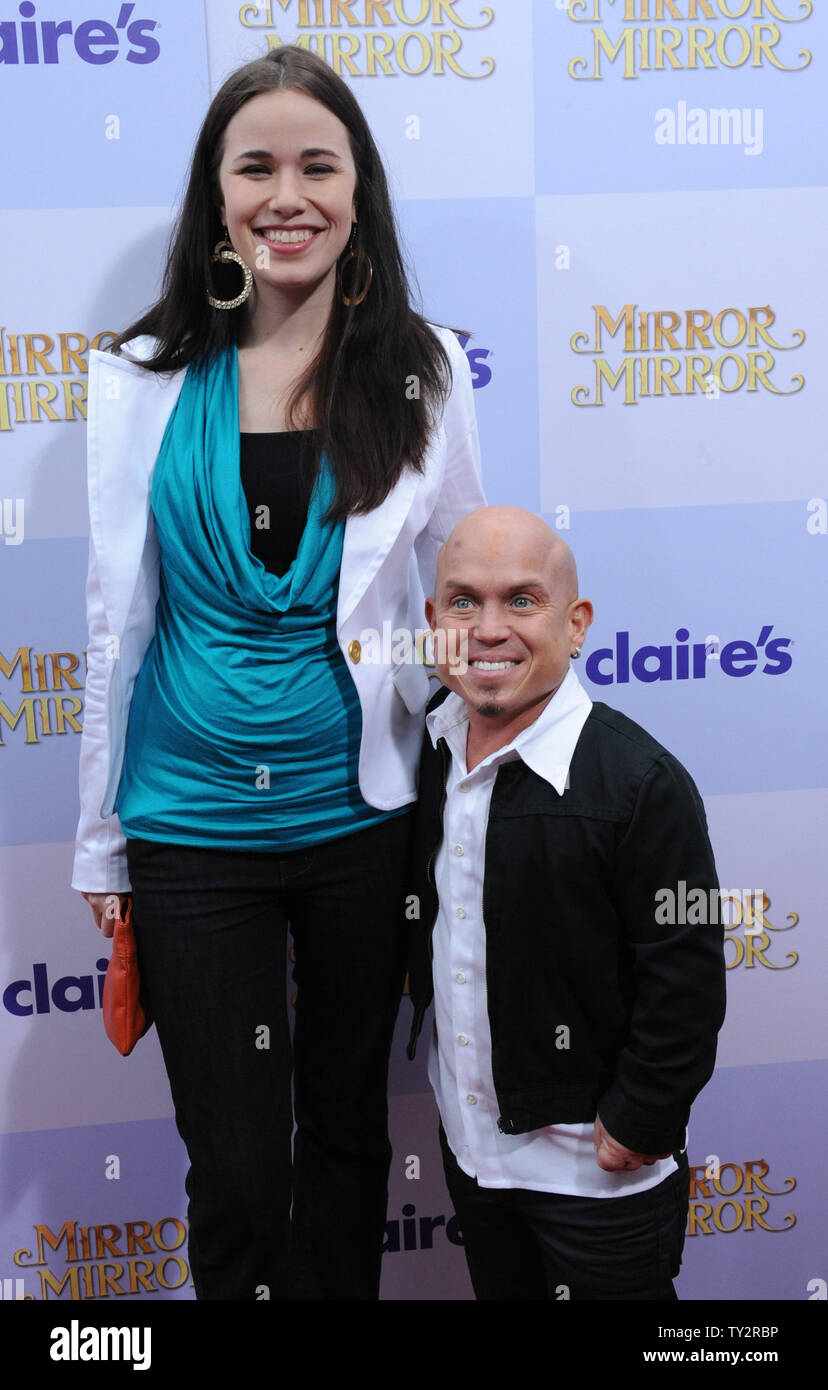 https://c8.alamy.com/comp/TY2RBP/actor-martin-klebba-a-cast-member-in-the-motion-picture-comedy-fantasy-mirror-mirror-attends-the-premiere-of-the-film-with-wife-michelle-at-graumans-chinese-theatre-in-the-hollywood-section-of-los-angeles-on-march-17-2012-at-right-is-director-tarsem-singh-upijim-ruymen-TY2RBP.jpg