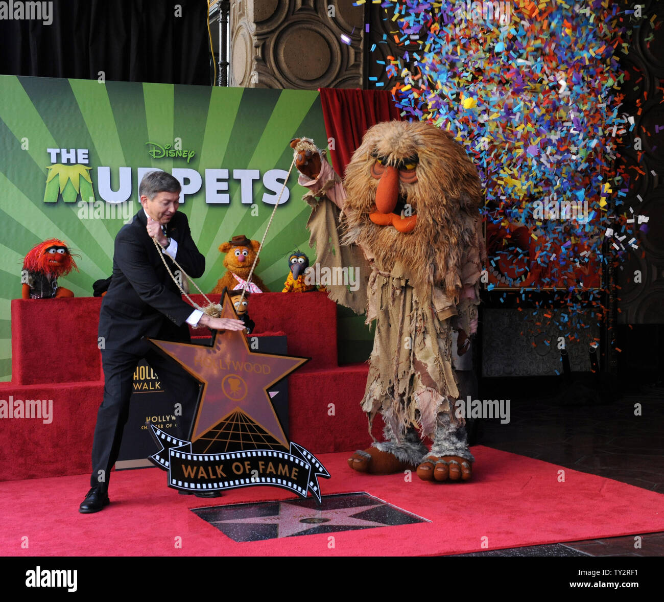 Sweetums (R) helps Hollywood Chamber of Commerce CEO Leron Gubler (L) during an unveiling ceremony honoring The Muppets  with the 2,466th star on the Hollywood Walk of Fame in Los Angeles on March 20, 2012. UPI/Jim Ruymen Stock Photo