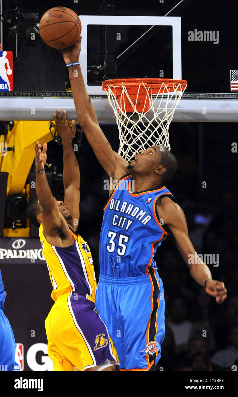 Los Angeles Lakers point guard Ramon Sessions (7) has his shot blocked by  Oklahoma City Thunder small forward Kevin Durant (35) in the second half of  an NBA basketball game in Los