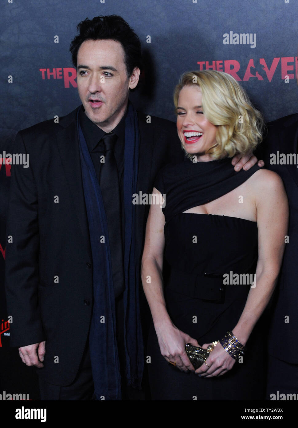 Actor John Cusack (L) and Alice Eve,  cast members in the motion picture mystery thriller 'The Raven', attend the premiere of the film at the Los Angeles Theatre in the downtown section of Los Angeles on April 23, 2012.   UPI/Jim Ruymen Stock Photo