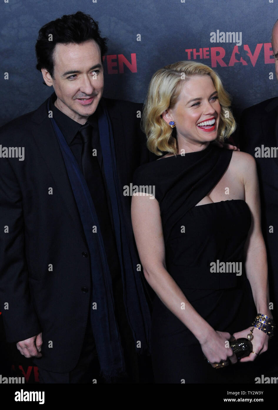 Actor John Cusack (L) and Alice Eve,  cast members in the motion picture mystery thriller 'The Raven', attend the premiere of the film at the Los Angeles Theatre in the downtown section of Los Angeles on April 23, 2012.   UPI/Jim Ruymen Stock Photo