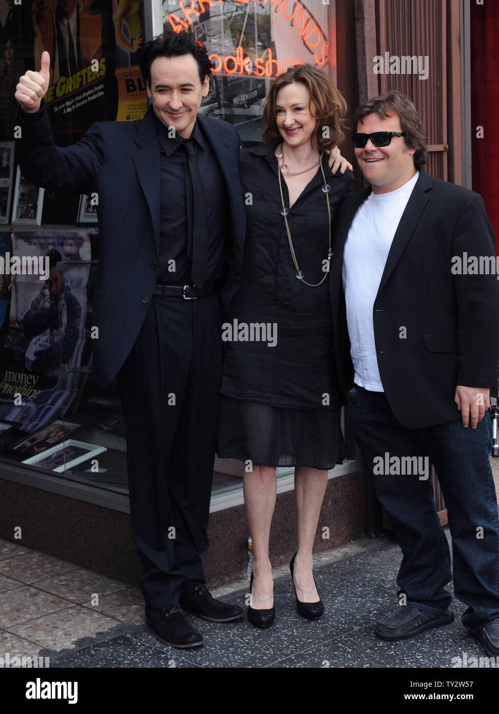 Actor John Cusack (L) poses with his sister, actress Joan Cusack (C) and  actor Jack Black during an unveiling ceremony honoring him with the 2,469th  star on the Hollywood Walk of Fame