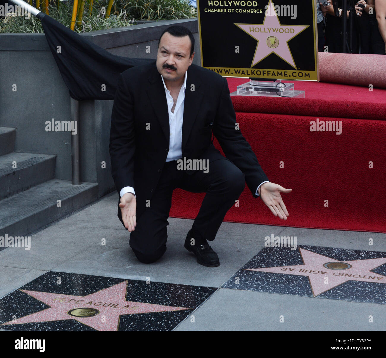 Latin singing star Pepe Aguilar of Mexico, poses between his father’s