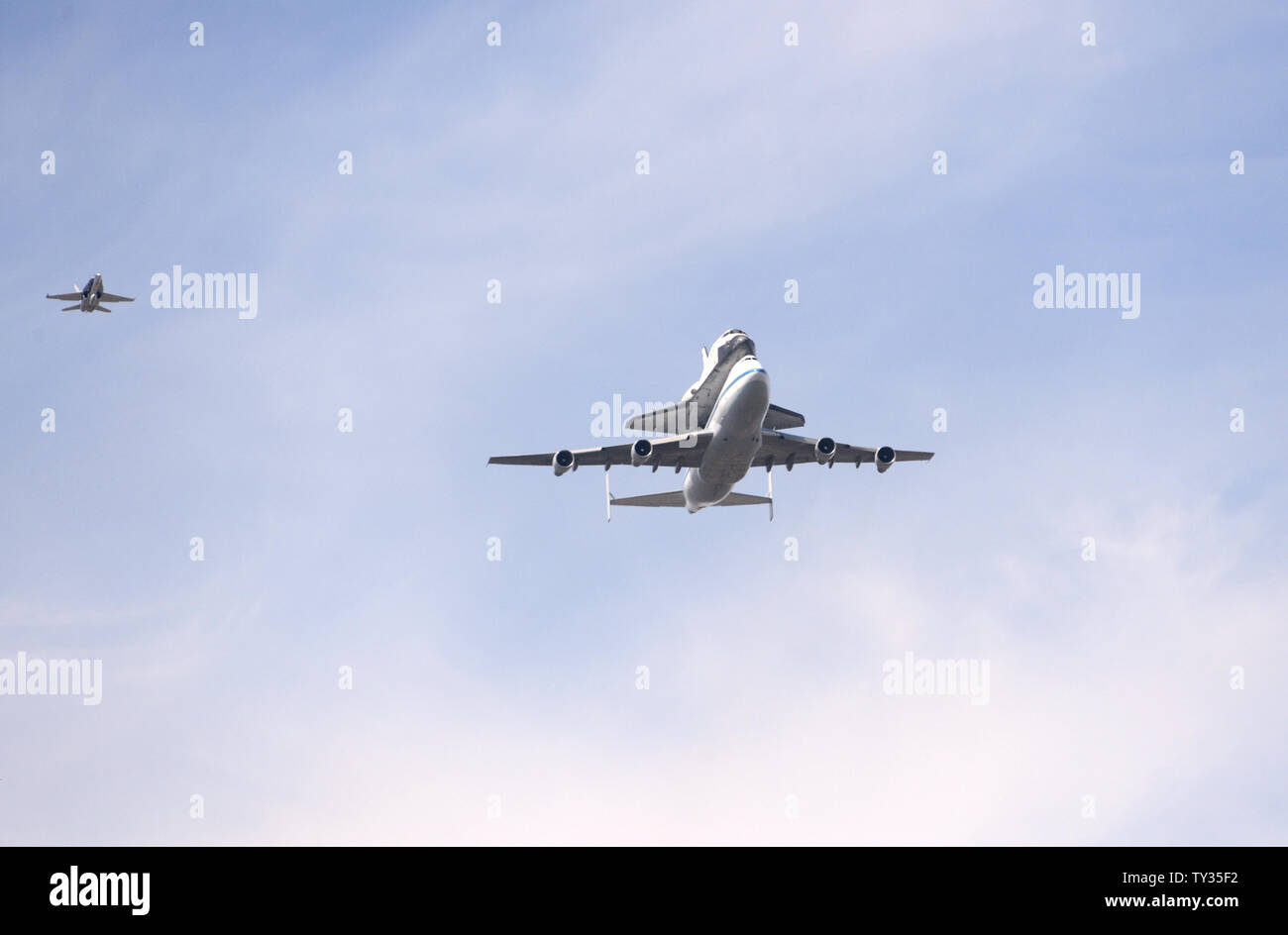 The space shuttle Endeavor is ferried atop a modified Boeing 747 jet on ...