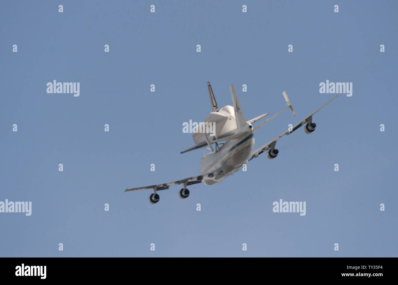The space shuttle Endeavor is ferried atop a modified Boeing 747 jet on ...