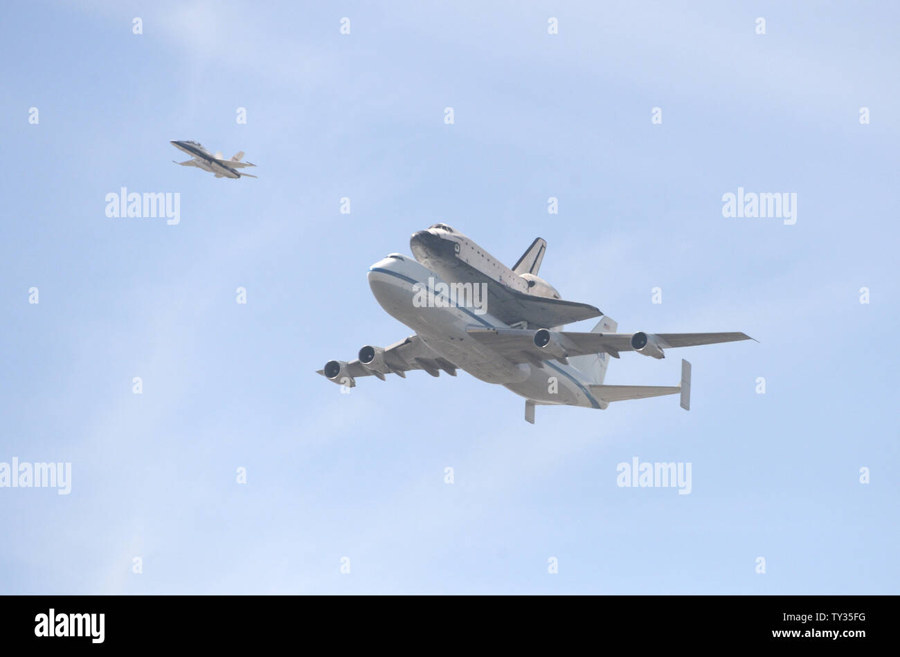 The space shuttle Endeavor is ferried atop a modified Boeing 747 jet on ...