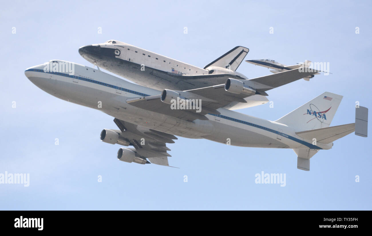 The space shuttle Endeavor is ferried atop a modified Boeing 747 jet on ...