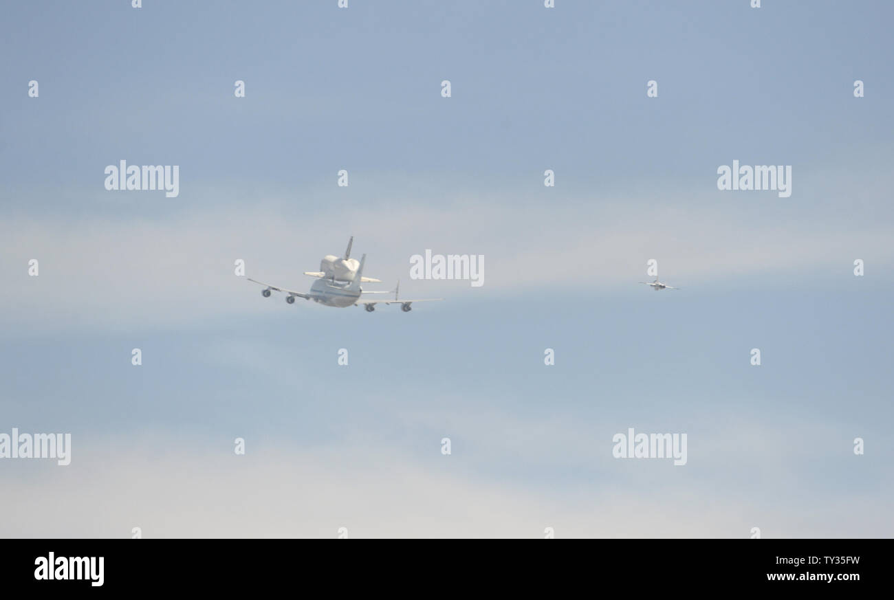 The space shuttle Endeavor is ferried atop a modified Boeing 747 jet on ...