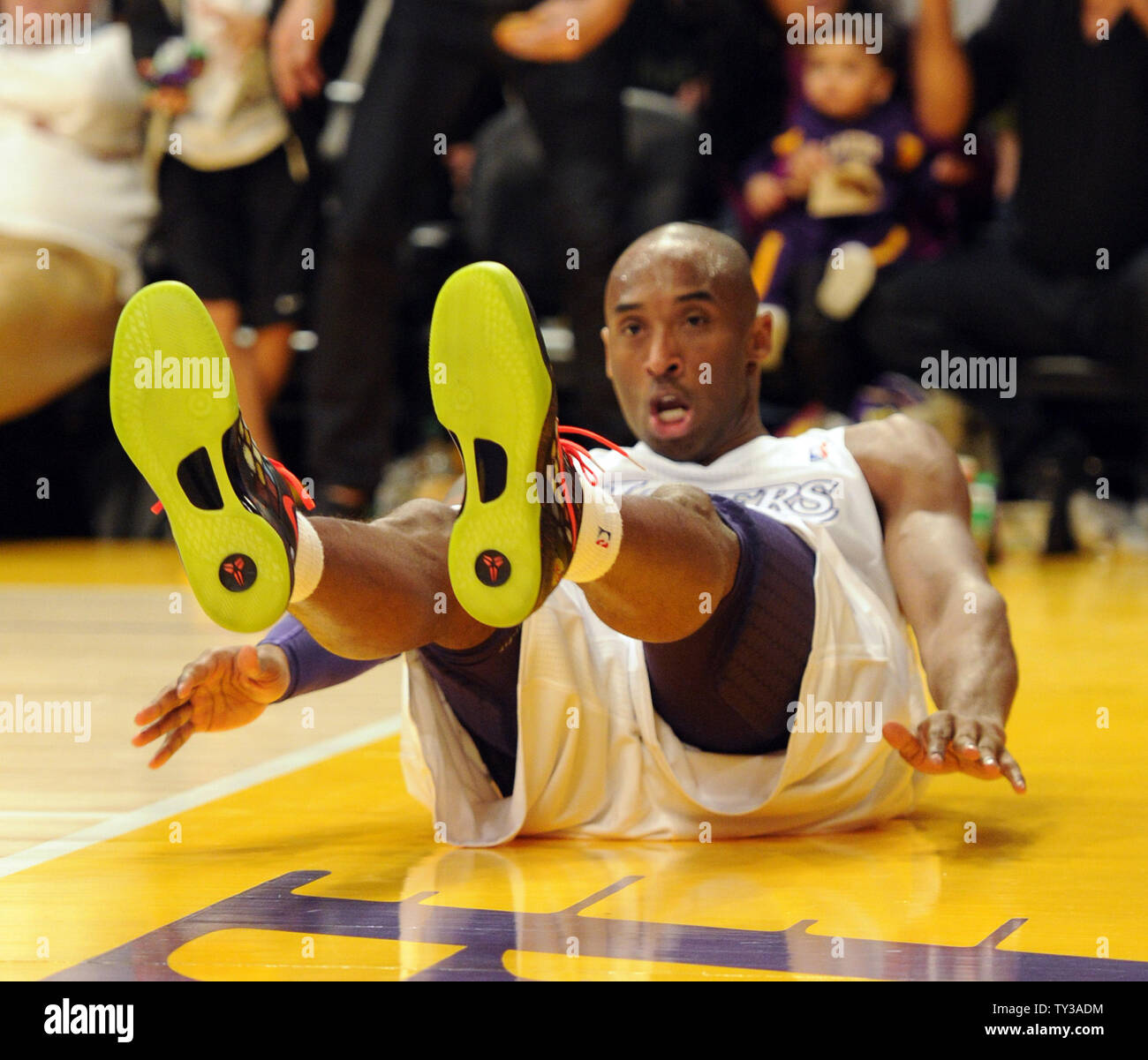 Los Angeles Lakers shooting guard Kobe Bryant lands on the court after making a basket against the New York Knicks in the first half of an NBA basketball game in Los Angeles on December 25, 2012.    UPI/Lori Shepler Stock Photo