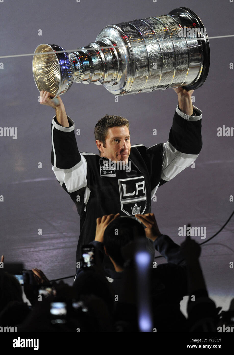 Los Angeles Kings Rob Scuderi holds up the Stanley Cup in a ceremony before  the game against the Chicago Blackhawks at Staples Center in Los Angeles,  California on January 19, 2013. UPI/Lori