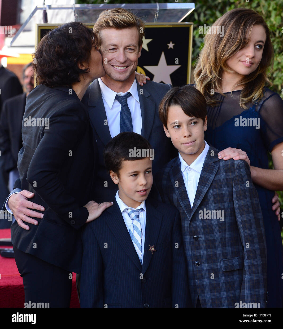 Australian actor Simon Baker (C) poses with his wife Rebecca Rigg and their sons Claude Blue and Harry Friday and daughter Stella Breeze (L-R) during an unveiling ceremony, honoring him with the 2,490th star on the Hollywood Walk of Fame in Los Angeles on February 14, 2013. UPI/Jim Ruymen Stock Photo