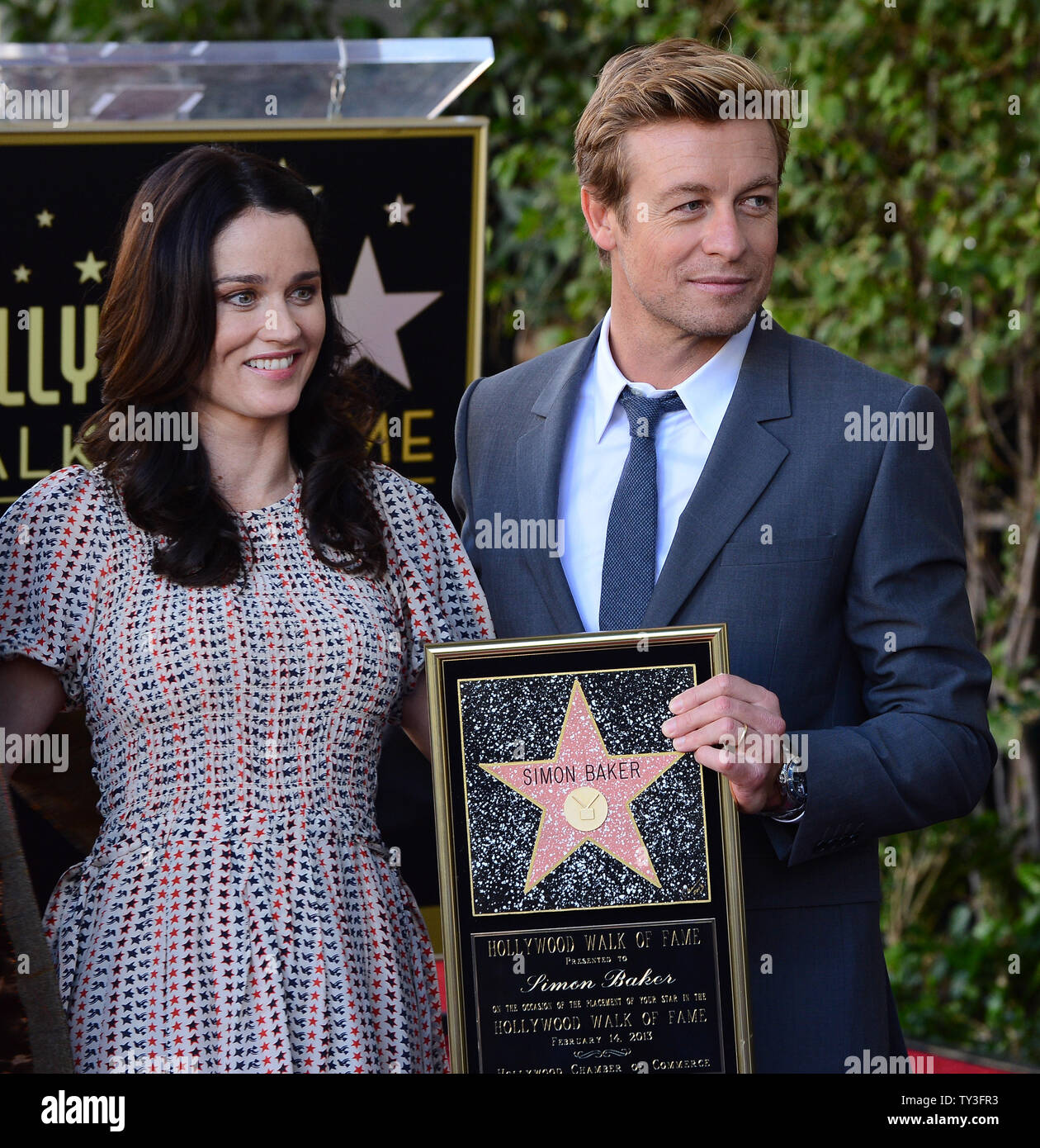 Australian actor Simon Baker poses with actress Robin Tunney, his co-star on the TV series 'The Mentalist', during an unveiling ceremony, honoring him with the 2,490th star on the Hollywood Walk of Fame in Los Angeles on February 14, 2013. UPI/Jim Ruymen Stock Photo