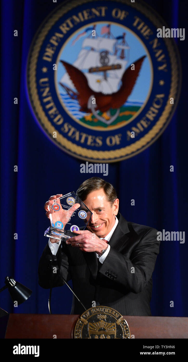Former CIA director David Petraeus displays a token of appreciation presented to him following Petraeus' address at a University of Southern California event honoring the military on March 26, 2013 in Los Angeles, California. In the first public appearance since stepping down last November as head of the CIA after admitting to an affair, Petraeus said he regretted and apologized for the circumstances that led to his resignation.   UPI/Jim Ruymen Stock Photo