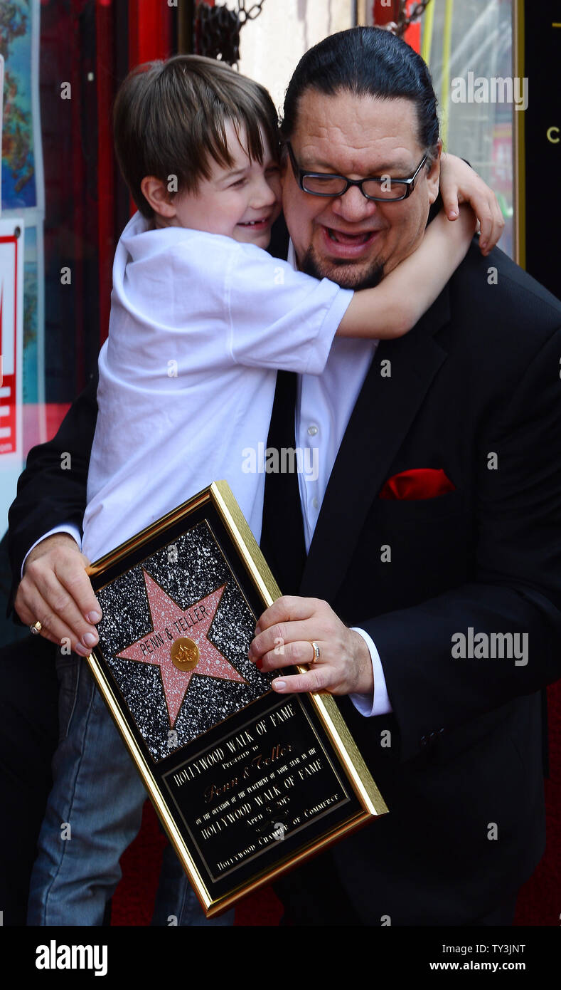 Penn Jillette  of the comedy/magic duo Penn & Teller is hugged by his son Zolten, during an unveiling ceremony, honoring the pair with the 2,494th star on the Hollywood Walk of Fame in Los Angeles on April 5, 2013.   UPI/Jim Ruymen Stock Photo