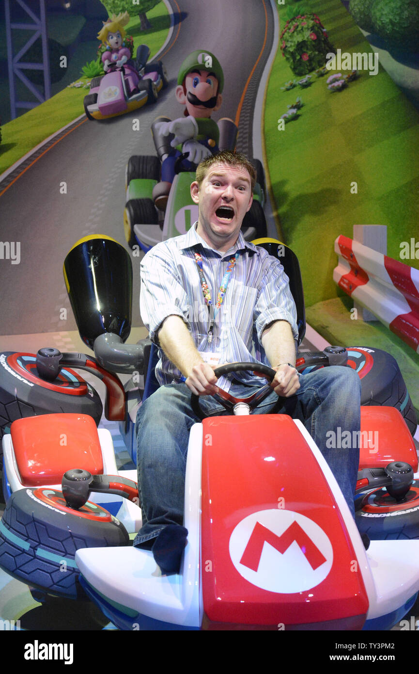 Fans pose pose for pictures at the MarioKart8 display during E3, the Electronic Entertainment Expo held at the LA Convention Center in Los Angeles on June 11, 2013.      UPI/Phil McCarten Stock Photo