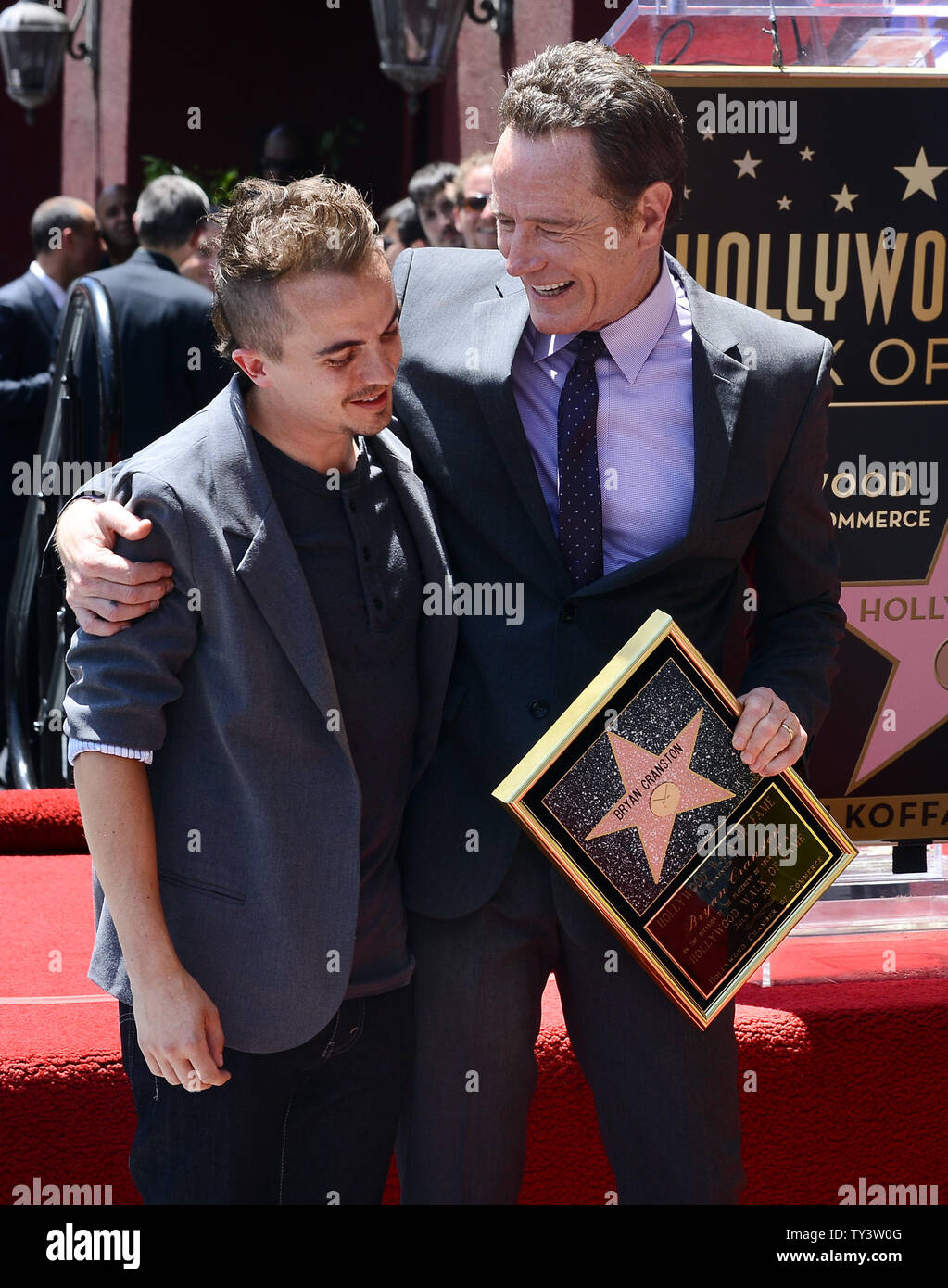 Actor Bryan Cranston (R) hugs former 