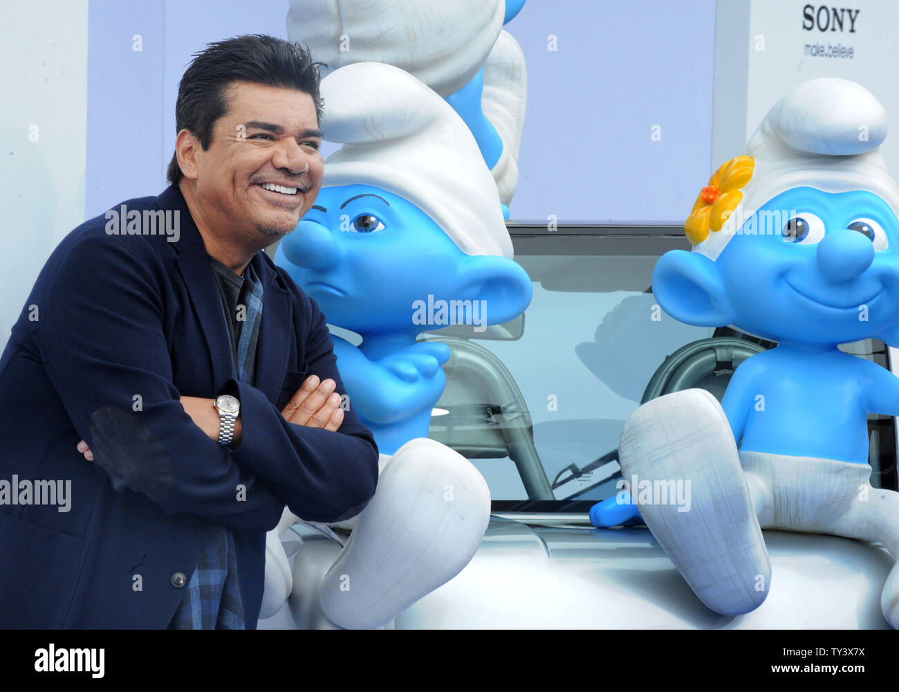 Actor and comedian George Lopez, the voice of Grouchy Smurf in the motion picture animated comedy 'The Smurfs 2', attends the premiere of the film at the Regency Village Theatre, in the Westwood section of Los Angeles on July 28, 2013. The Smurfs join forces with their human friends to rescue Smurfette, who has been kidnapped by Gargamel since she knows a secret spell that can turn the evil sorcerer's newest creation - creatures called the Naughties - into real Smurfs.  UPI/Jim Ruymen Stock Photo