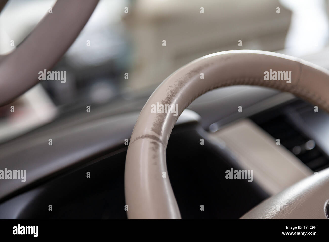 Car Interior With A Beige Leather Steering Wheel Close Up