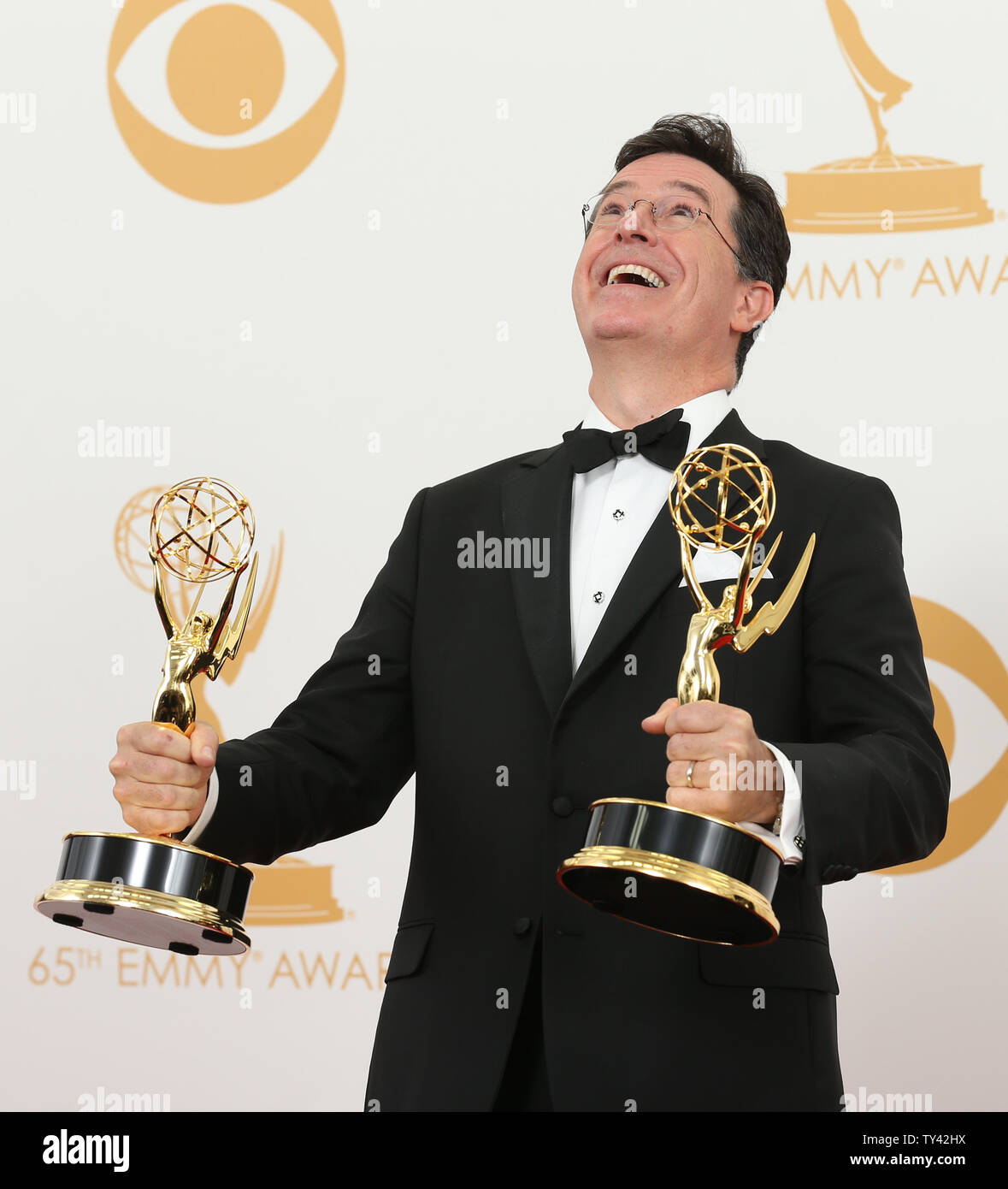 Writer Stephen Colbert holds the award he won for  'Outstanding Writing for a Variety Series - .The Colbert Report' at the 65th Primetime Emmy Awards at Nokia Theatre in Los Angeles on September 22, 2013.   UPI/Danny Moloshok Stock Photo