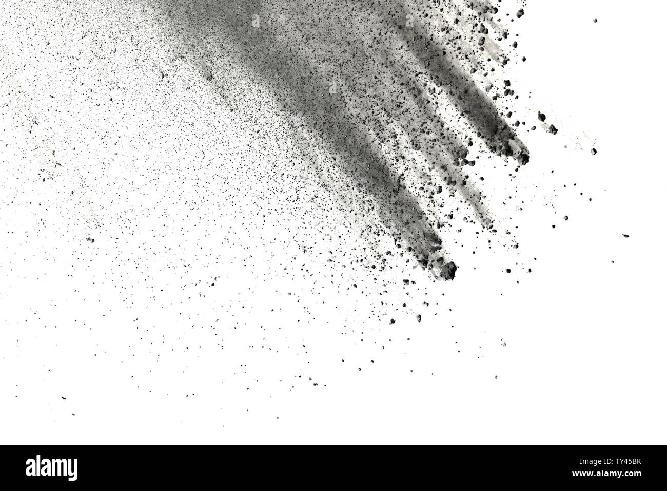 Black particles splattered on white background. Black powder dust