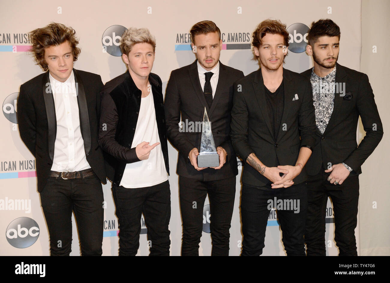 (L-R) Recording artists Harry Styles, Niall Horan, Liam Payne, Louis Tomlinson, and Zayn Malik of music group One Direction hold the award they won for Favorite Album - Pop/Rock for 'Take Me Home' and Favorite Band, Duo or Group - Pop/Rock, backstage at the 41st annual American Music Awards held at Nokia Theatre L.A. Live in Los Angeles on November 24, 2013.  UPI/Phil McCarten Stock Photo
