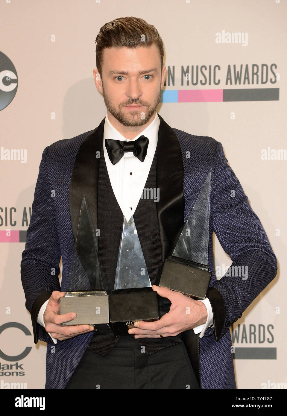 Recording artist Justin Timberlake holds the awards he won for Favorite Male Artist - Pop/Rock, Favorite Male Artist - Soul/R&B, and Favorite Album - Soul/R&B for 'The 20/20 Experience', backstage at the 41st annual American Music Awards held at Nokia Theatre L.A. Live in Los Angeles on November 24, 2013.  UPI/Phil McCarten Stock Photo