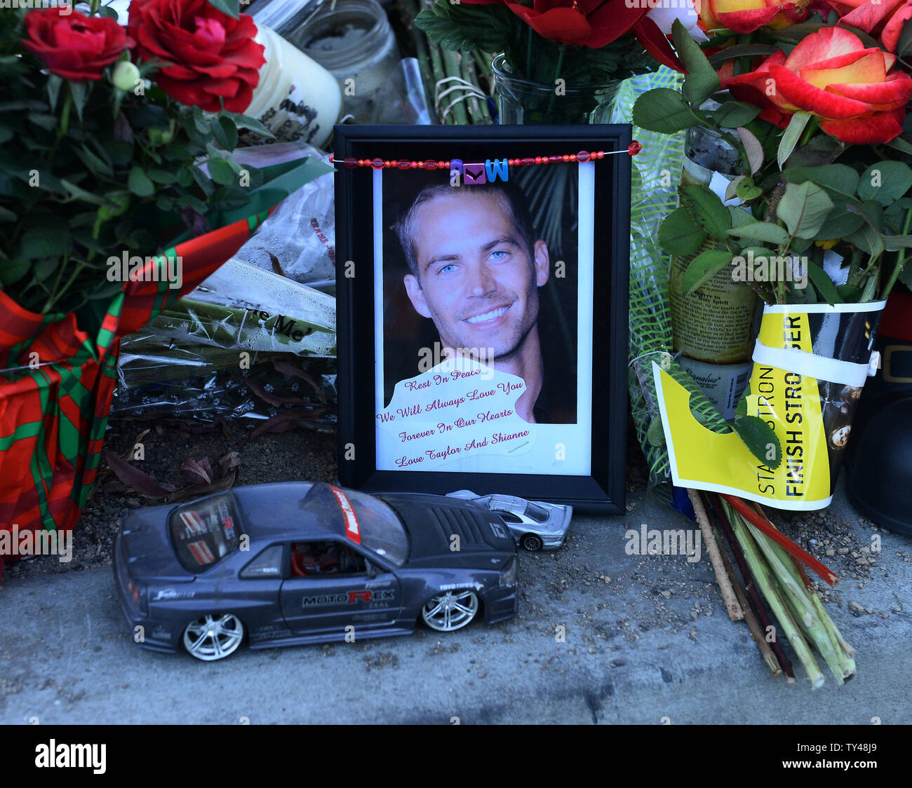 Fans gather at a makeshift memorial to pay respects at the site of the  fiery car accident in which actor Paul Walker was killed in Santa Clarita,  California, on December 4, 2013.