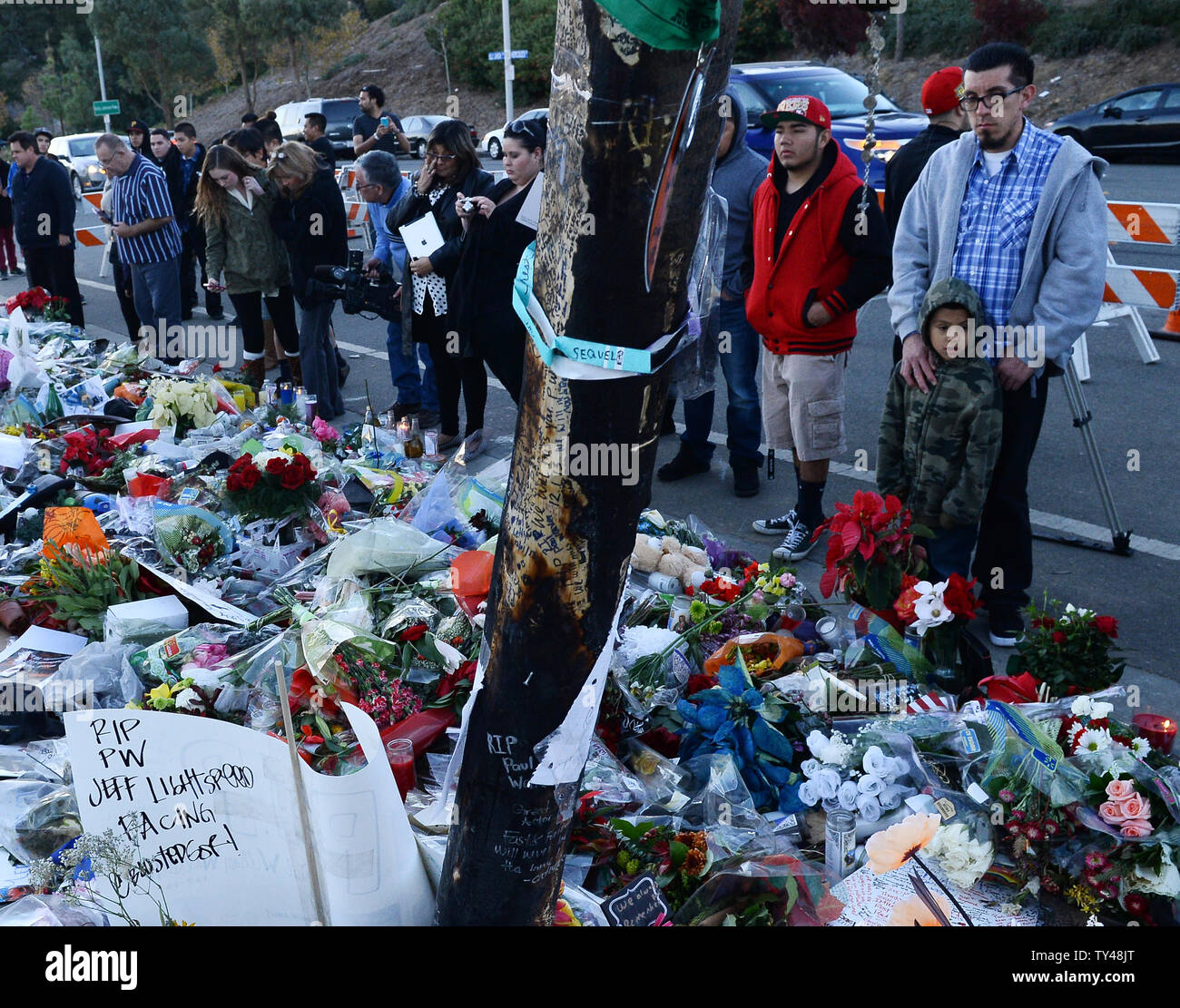 Fans gather at a makeshift memorial to pay respects at the site of the fiery car accident in which actor Paul Walker was killed in Santa Clarita, California, on December 4, 2013. Fans and fellow actors mourned the death of Paul Walker, who died in a fiery car crash on Saturday, December 1, 2013. Walker, 40, who was best known as undercover agent Brian O'Connor in the 'Fast and Furious' action movies, appeared in all but one of the six movies in the popular franchise, and was a leading protagonist along with Vin Diesel and Michelle Rodriguez. UPI/Jim Ruymen Stock Photo