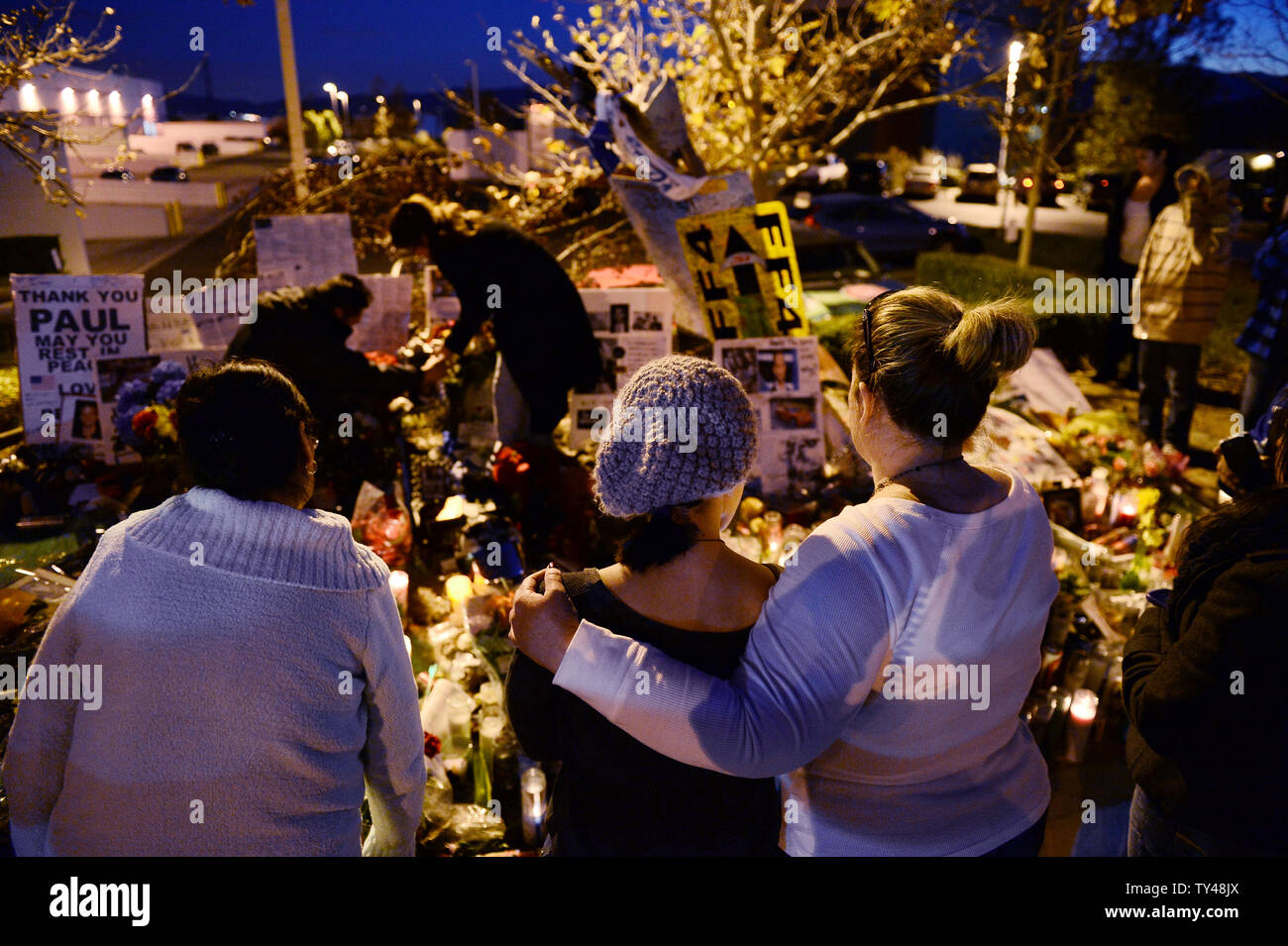 Fans gather at a makeshift memorial to pay respects at the site of the fiery car accident in which actor Paul Walker was killed in Santa Clarita, California, on December 4, 2013. Fans and fellow actors mourned the death of Paul Walker, who died in a fiery car crash on Saturday, December 1, 2013. Walker, 40, who was best known as undercover agent Brian O'Connor in the 'Fast and Furious' action movies, appeared in all but one of the six movies in the popular franchise, and was a leading protagonist along with Vin Diesel and Michelle Rodriguez. UPI/Jim Ruymen Stock Photo