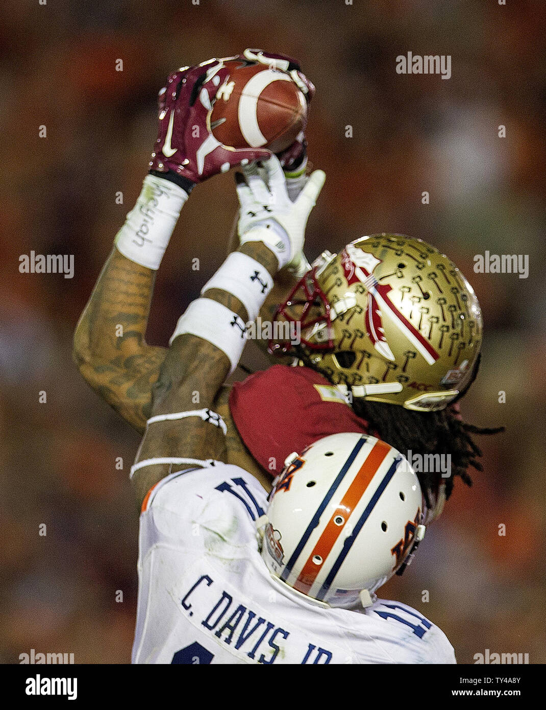 Florida State Seminoles receiver Kelvin Benjamin makes the game-winning touchdown catch over Auburn Tiger cornerback Chris Davis with 13 seconds left in the BCS national title college game at the Rose Bowl in Pasadena, California on January 6, 2014.   Heisman Trophy winner quarterback Jameis Winston threw the two-yard pass.   Florida State defeated Auburn by a score of 34-31.  (RECROP)  UPI/Mark Wallheiser Stock Photo