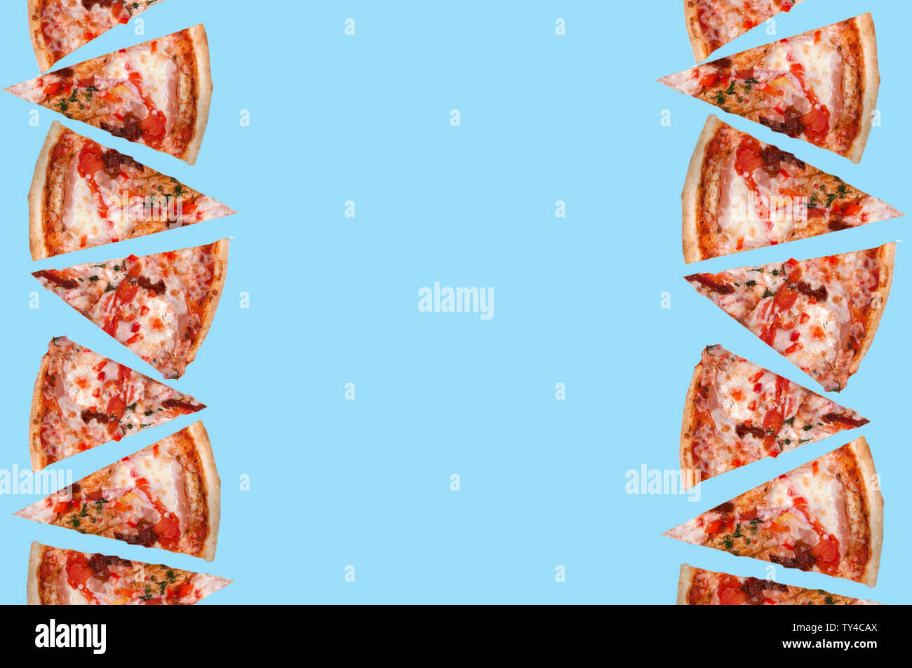 many triangular slices of pizza double row on the right and left side in the middle of the image free space on a light green background top view Stock Photo
