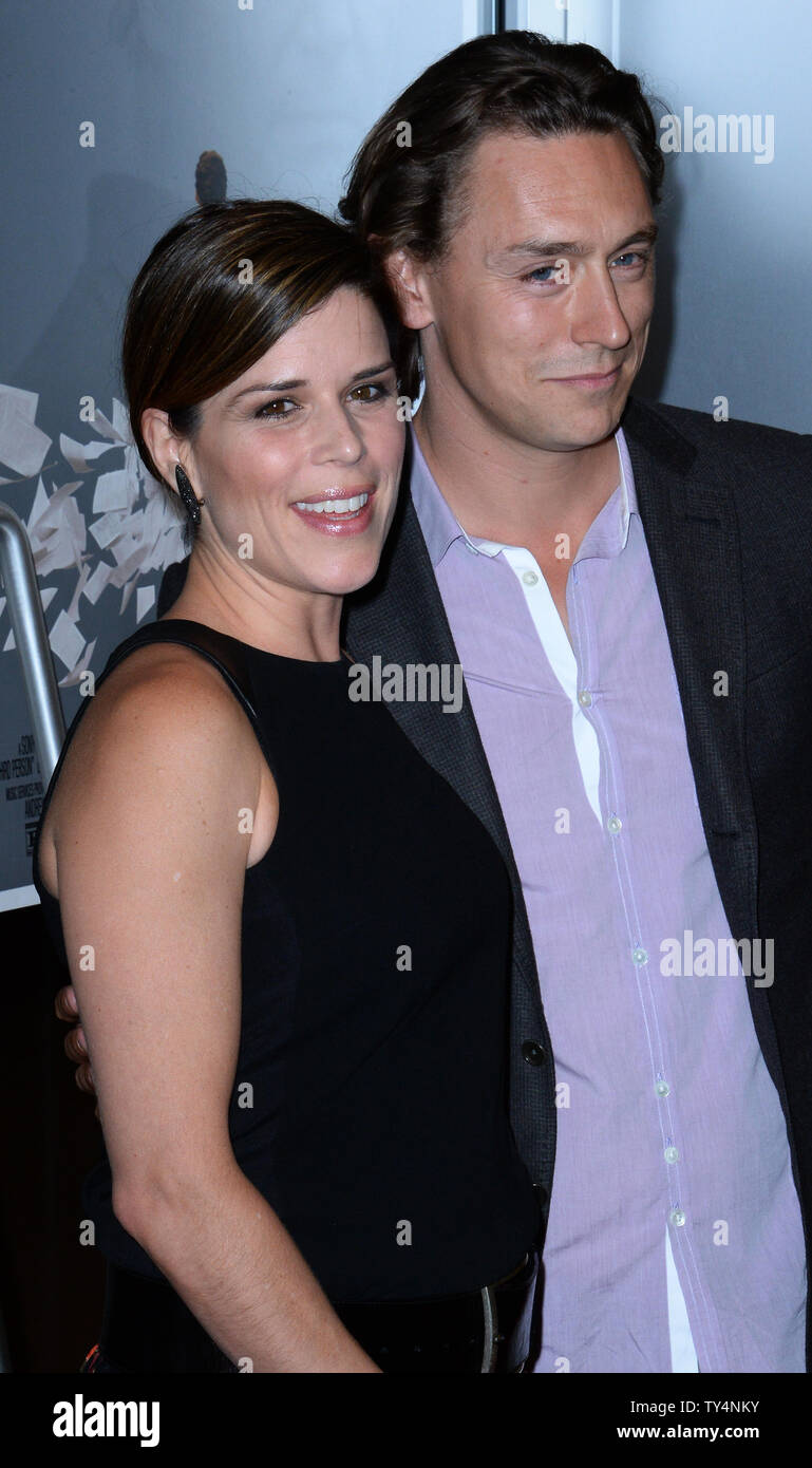 Actors Neve Campbell (L) and JJ Feild attend the premiere of the motion