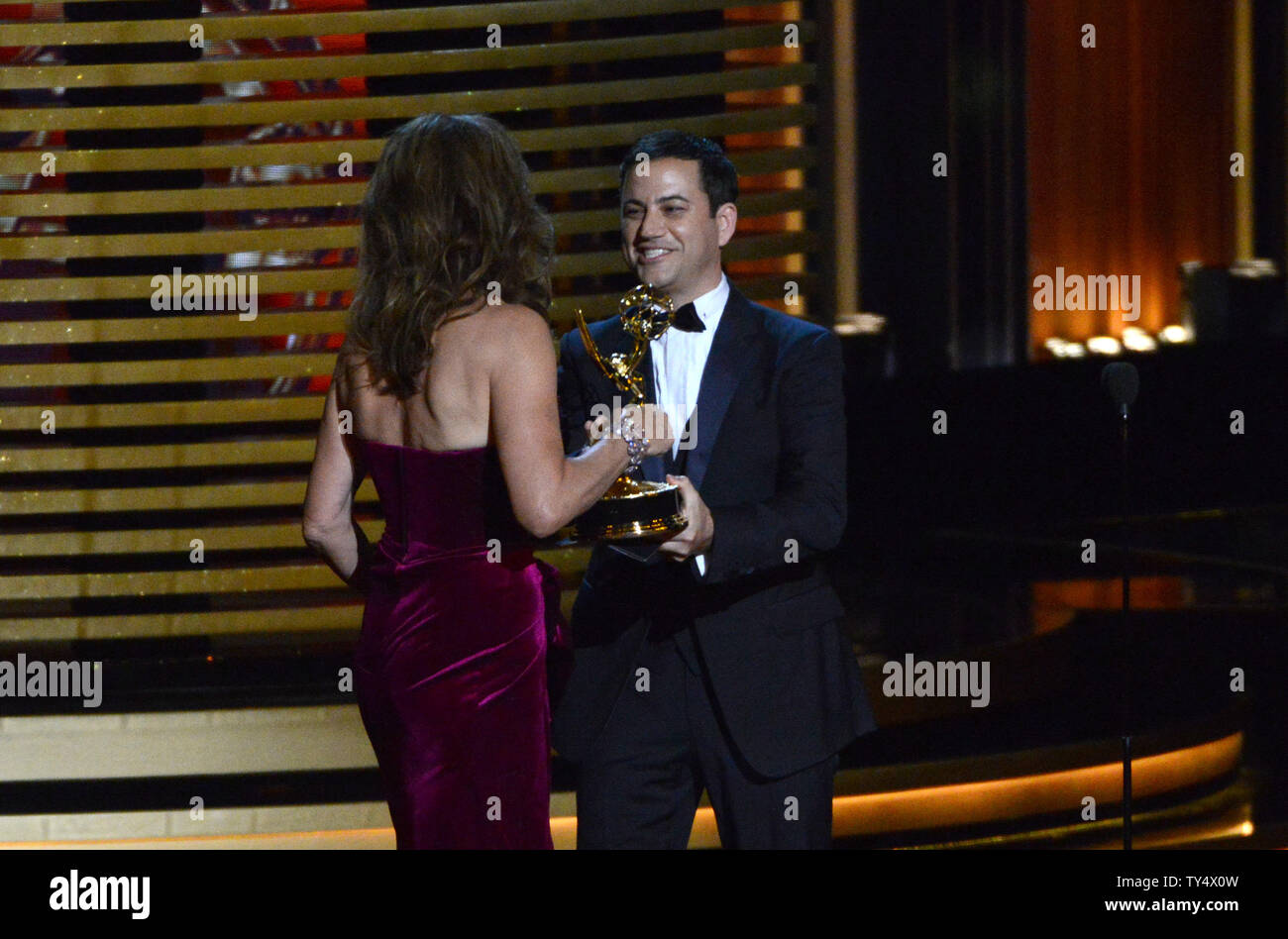 Jimmy Kimmel, right, presents the award for outstanding supporting