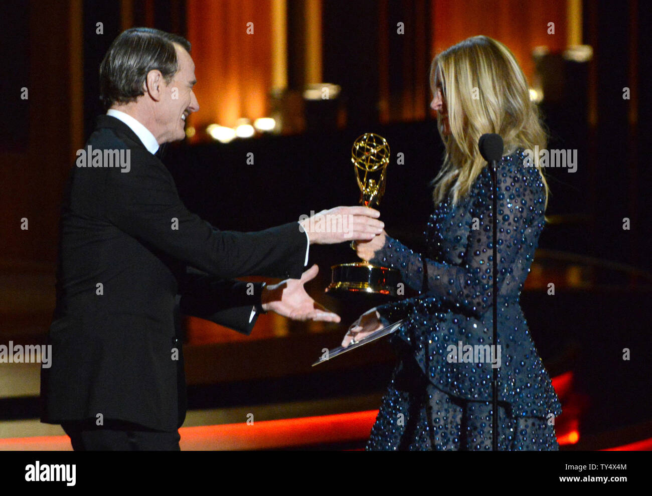 Julia Roberts, right, presents Bryan Cranston with the award for outstanding lead actor in a drama series for his work in 'Breaking Bad' during the Primetime Emmy Awards at the Nokia Theatre in Los Angeles on August 25, 2014.     UPI/Pat Benic Stock Photo