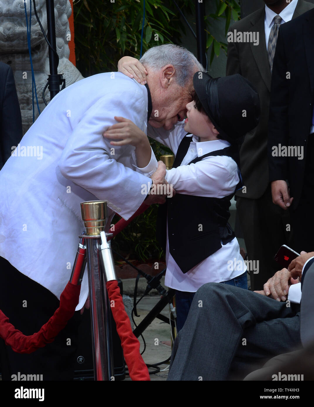 Writer/director/actor Mel Brooks is hugged by his grandson Henry Michael Brooks following Brooks' hands & footprints ceremony in the forecourt of the TCL Chinese Theatre (formerly Grauman's), in the Hollywood section of Los Angeles on September 8, 2014. The award-winning filmmaker wore a prosthetic sixth finger on one hand to add a little extra charm while pressing his feet and hands into cement. The 88-year-old comedian is celebrating the 40th anniversary of his Oscar-nominated film, "Young Frankenstein."  UPI/Jim Ruymen Stock Photo