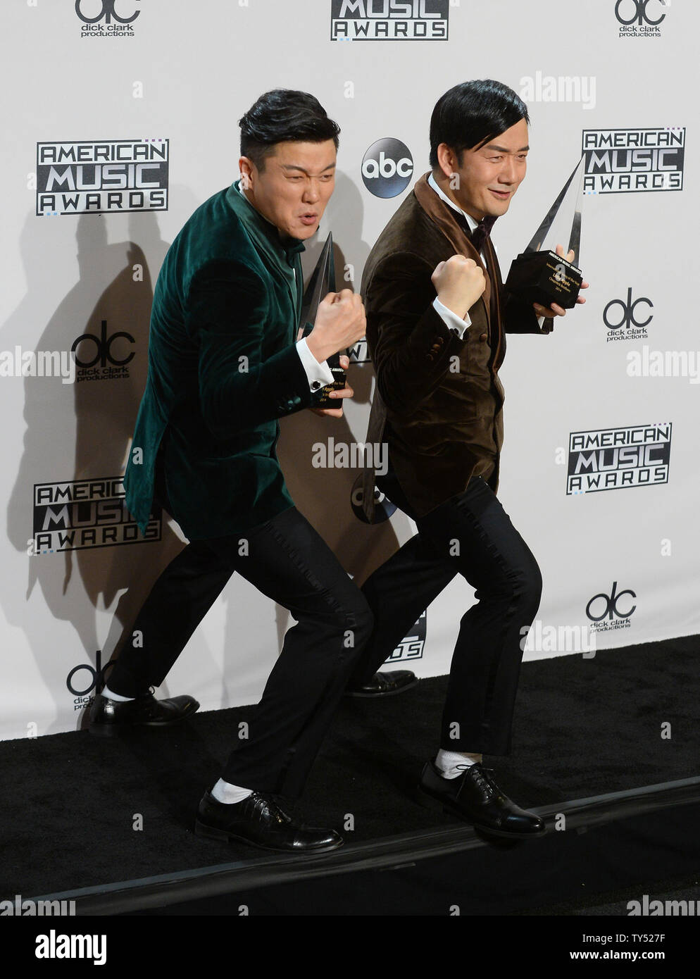 Chinese music duo Xiao Yang, left, and Wang Taili of the Chopstick Brothers,  pose backstage with the Best International Song AwardÓ for ÒLittle Apple"  at the 42nd annual American Music Awards held