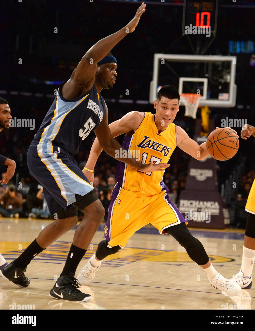 Los Angeles Lakers guard Jeremy Lin (17) dribbles around Memphis Grizzlie forward Zach Randolph (50) during the first half of their NBA game at Staples Center in Los Angeles, November 26, 2014.   UPI/Jon SooHoo Stock Photo