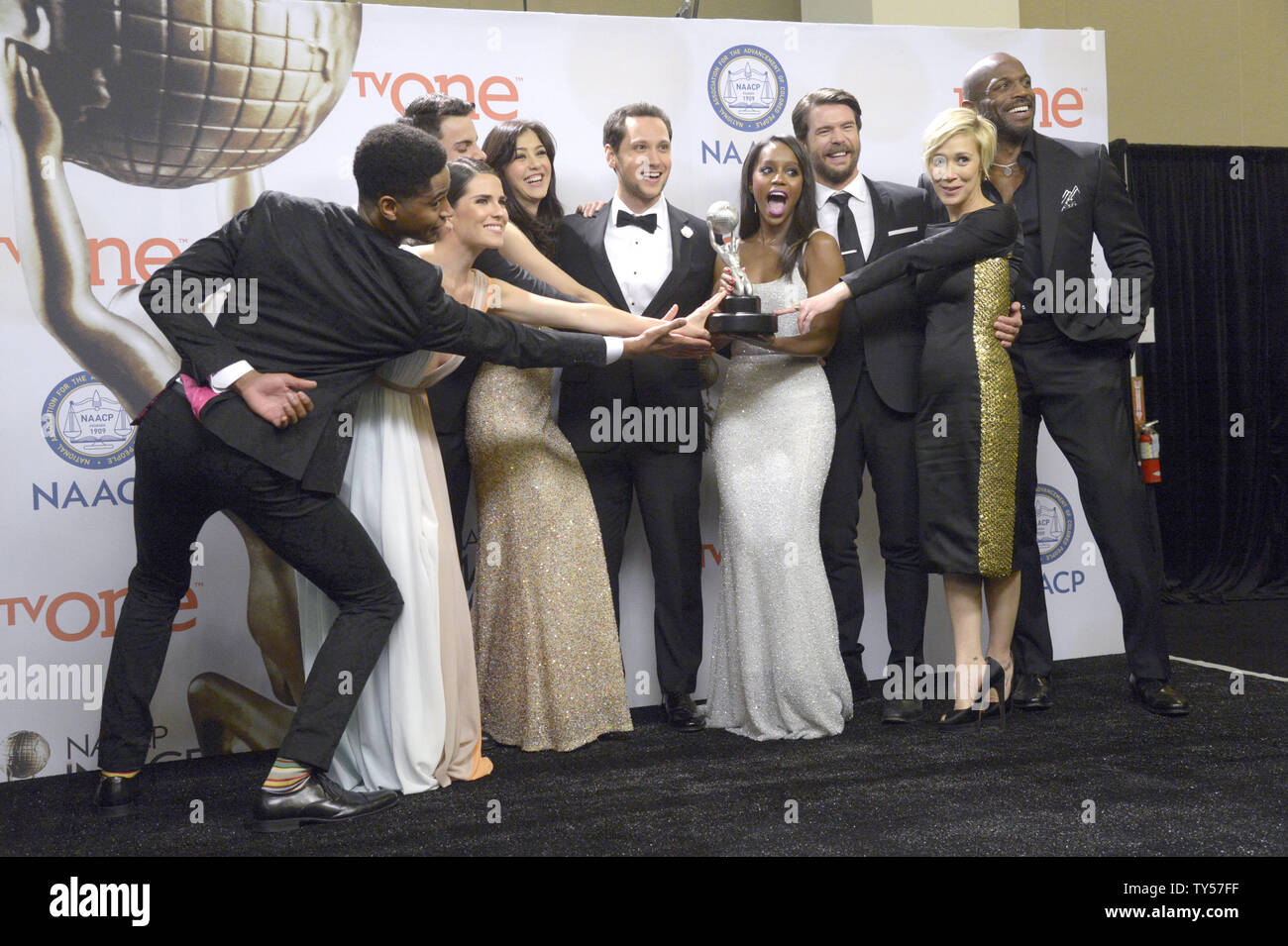 (L-R) Actors Alfred Enoch, Karla Souza, Jack Falahe, Katie Findlay, Matt McGorry, Aja Naomi King, Charlie Weber, Liza Weil and Billy Brown of  'How to Get Away with Murder' pose backstage withe award for Outstanding Drama Series during the 46th NAACP Image Awards at the Pasadena Civic Auditorium in Pasadena, California on February 6, 2015. The NAACP Image Awards celebrates the accomplishments of people of color in the fields of television, music, literature and film and also honors individuals or groups who promote social justice through creative endeavors.  Photo by Phil McCarten/UPI Stock Photo