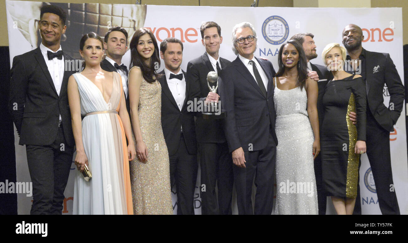 (L-R) Actors Alfred Enoch, Karla Souza, Jack Falahe, Katie Findlay, Matt McGorry, producer Peter Nowalk, producer Bill D' Elia, actress Aja Naomi King, actor Charlie Weber and actor Billy Brown of  'How to Get Away with Murder' pose backstage with the award for Outstanding Drama Series during the 46th NAACP Image Awards at the Pasadena Civic Auditorium in Pasadena, California on February 6, 2015. The NAACP Image Awards celebrates the accomplishments of people of color in the fields of television, music, literature and film and also honors individuals or groups who promote social justice throug Stock Photo