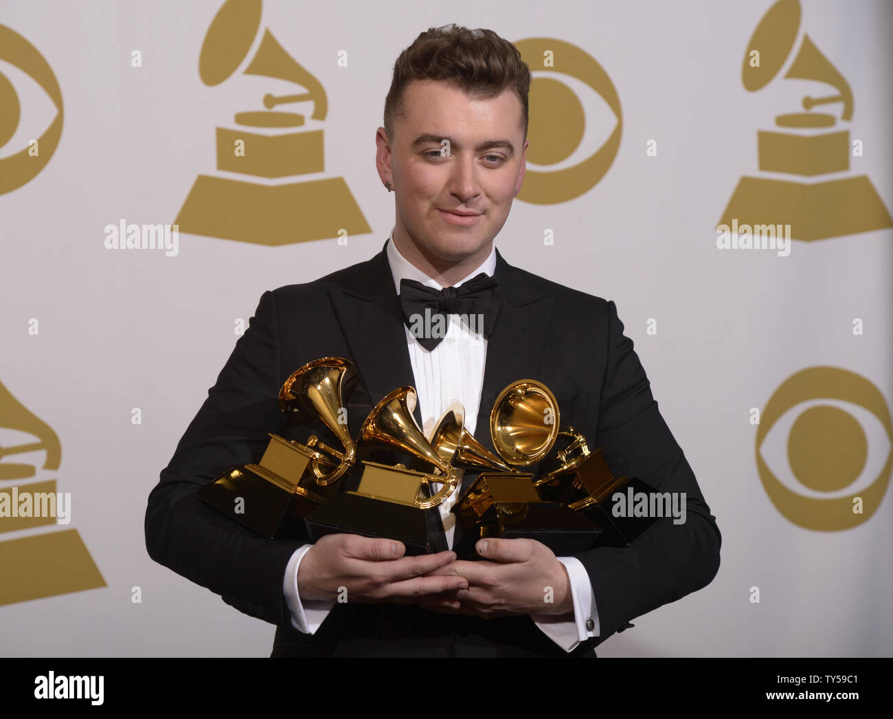 Sam Smith poses backstage with his awards for Record of the Year, Best