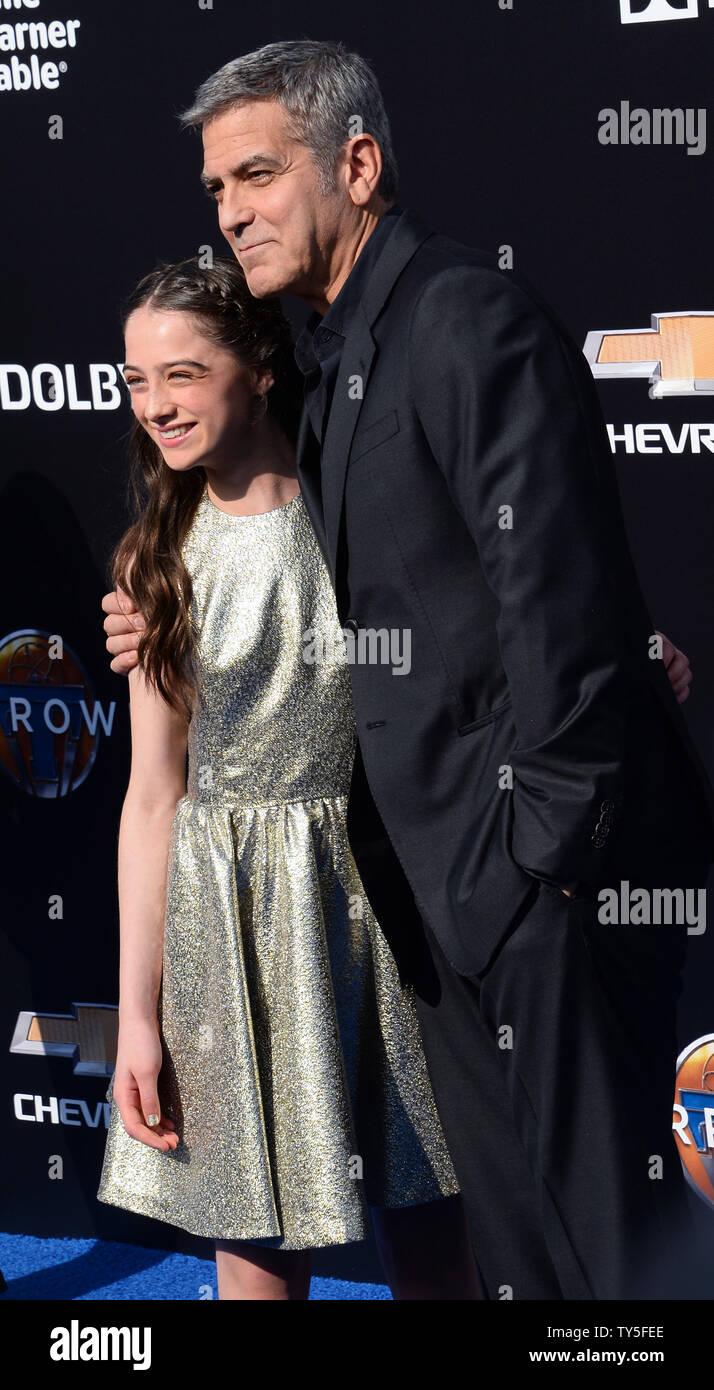 Cast members Raffey Cassidy and George Clooney attend the premiere of the  sci-fi motion picture mystery "Tomorrowland" at Disneyland in Anaheim,  California on May 9, 2015. Storyline: Bound by a shared destiny,