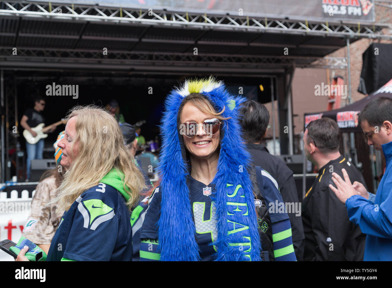 On game day, Seattle Seahawks fans dressed in their team jersey enjoy the pre game tailgate party hosted by a local radio station for the home game. Stock Photo