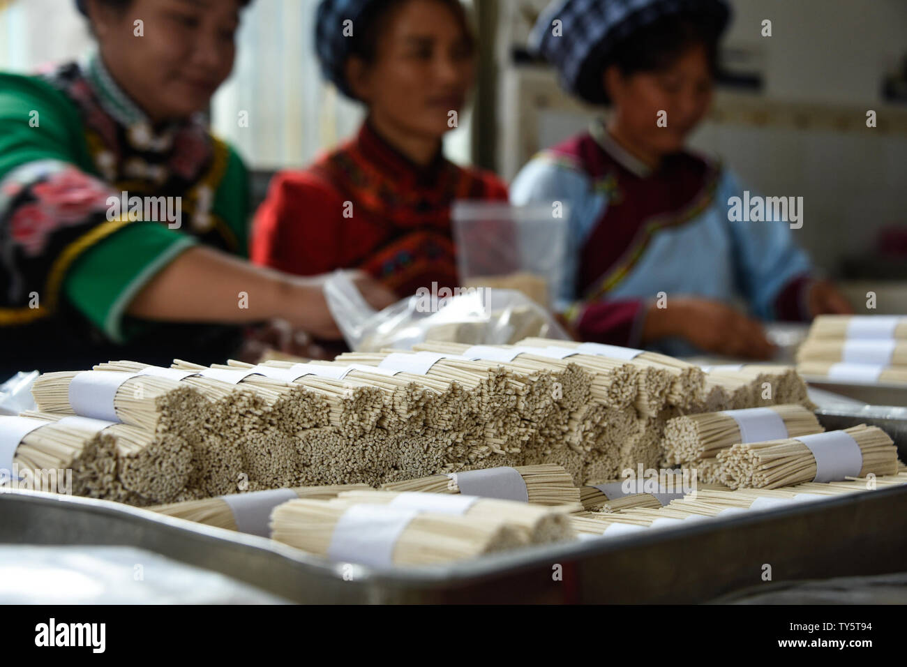 June 26, 2019 - Guizhou, Guizhou, China - Guizhou, China - June 26 2019:Saltwater noodles are one of the specialties of baoshu village, shitun town, wangmo county, buyi and miao autonomous prefecture, southwest guizhou province. It originated in qianlong period and has a history of more than 200 years.Saltwater noodles are called health food by local people in buyi. They are soft, delicious, lube, nutritious and easy to digest.Bao shu is an ordinary village with more than 200 families, all of whom make noodles for a living.Making Saltwater noodles have become not only the name card of the vill Stock Photo