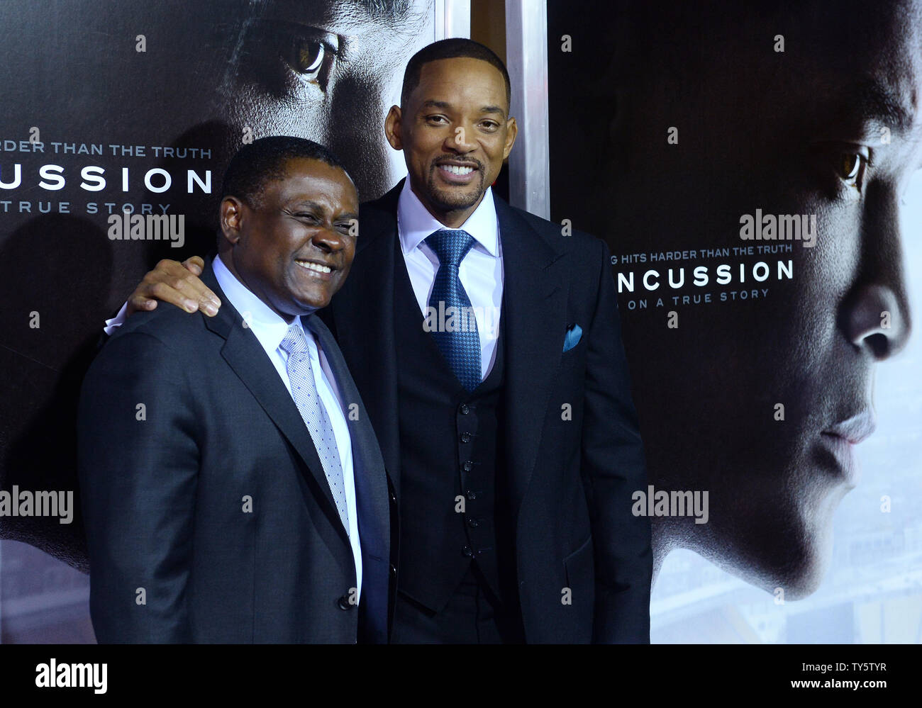 Cast member Will Smith (R) and Dr. Omalu attend a screening of