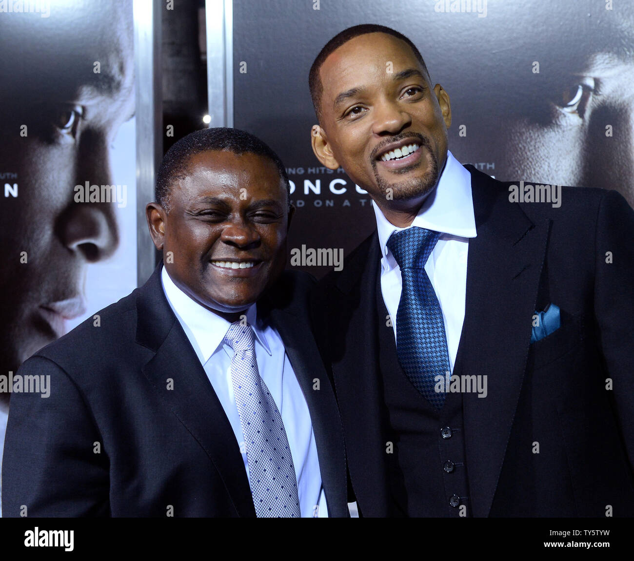 Cast member Will Smith (R) and Dr. Omalu attend a screening of