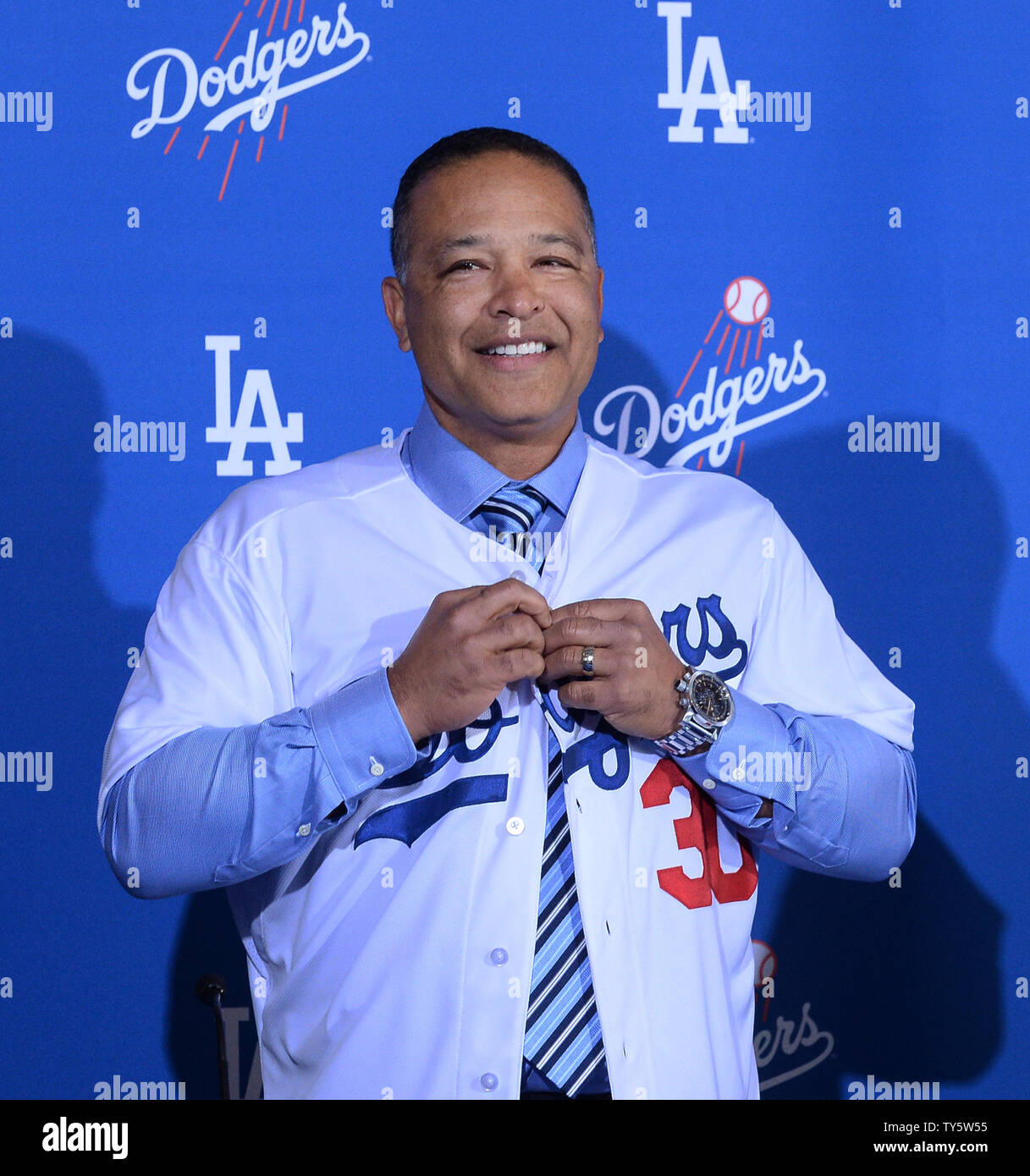 Dave Roberts, a former Dodger dons his new jersey as he is introduced as  the 10th manager of the Los Angeles Dodgers and the 28th in franchise  history, saying the post was